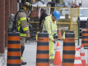 Windsor Fire and Rescue and Enbridge Gas officials investigate after a gas line was struck during work in the 100 block of Chatham Street West on Friday.