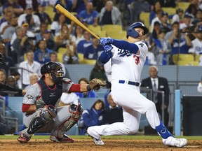 Los Angeles Dodgers left fielder Joc Pederson follows through on a swing for a solo home run during the eighth inning in game one of the 2019 NLDS playoff baseball series against the Washington Nationals at Dodger Stadium.