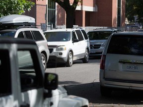 Illegally parked vehicles line Chilver Road by King Edward Public School in Windsor on Oct. 8, 2019.