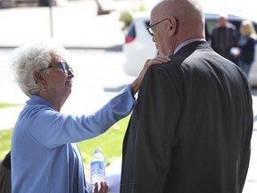 Denise Morneau is shown Thursday outside the Superior Court building in downtown Windsor, thanking Dr. David Eden, the coroner who presided over an inquest into the deaths of two local men, including Morneau's son Rob, 44, who died while on the job after falling from a factory rooftop. A coroner's jury returned with a list of recommendations on Oct. 10, 2019.