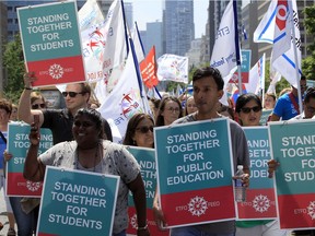 FILE - Ontario elementary teachers supporters make their way up University Ave in protest to the sex-ed rollback at Queen's Park in Toronto Tuesday August 14, 2018.