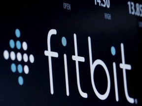 FILE PHOTO: The ticker symbol for Fitbit is displayed at the post where it is traded on the floor of the New York Stock Exchange (NYSE) February 23, 2016.