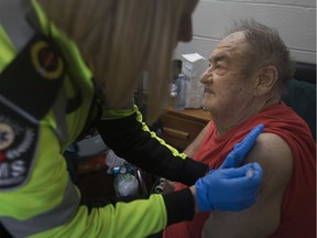 EMS Paramedic, Krista Hillier administers a flu shot to Joseph Lustig at his home on Campbell Avenue, Monday, October 28, 2019.