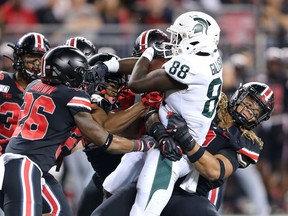 Michigan State Spartans tight end Trenton Gillison tackled by Ohio State Buckeyes defensive end Chase Young and cornerback Cameron Brown during the third quarter at Ohio Stadium.
