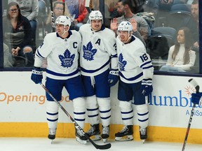 Toronto Maple Leafs' centre Auston Matthews (middle) celebrates with teammates centre John Tavares (91) and left wing Andreas Johnsson (18) after scoring a goal against the Columbus Blue Jackets in the third period at Nationwide Arena.