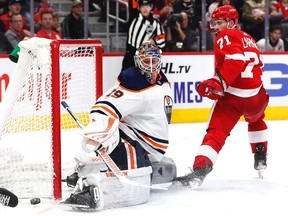 Edmonton Oilers goaltender Mikko Koskinen (19) makes a save against Detroit Red Wings center Dylan Larkin (71) in the second period at Little Caesars Arena.