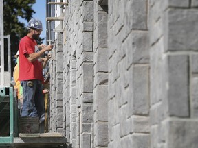 "Windsor hasn't seen this in years." Workers are shown at the West Bridge Place apartment complex under construction at the corner of Wyandotte Street West and Crawford Avenue on Wednesday, Oct. 9, 2019.