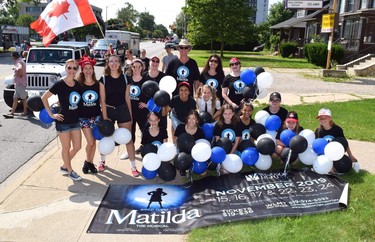 Cast members of Matilda the Musical pose for a photo during the Windsor Light Music Theatre's  participation in the Canada Day Parade.