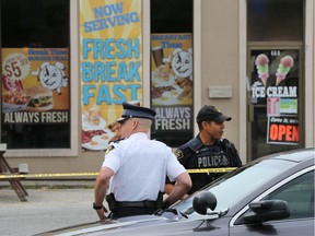 Leamington OPP are seen outside the Break Time Corner Restaurant in Leamington on June 29, 2017, during an investigation into the death of Du Weiqiong the day before. Her husband, Cheng Sun is on trial in Superior Court on a charge of second-degree murder.