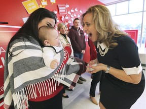 Liberal Windsor West candidate Sandra Pupatello, right, greets 4 month-old Leonardo Rivera and his mother Bianca Rivera at a news conference in Windsor on Friday, October 18, 2019.