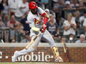 Cardinals batter Marcell Ozuna hits a two-run double against the Braves during ninth inning action in Game 1 of the National League Division Series at SunTrust Park in Atlanta, on Thursday, Oct. 3, 2019.