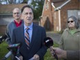 NDP candidate for Windsor West, Brian Masse, is joined by Mike Cardinal, left, owner of Sandwich's Cardinal Place, and Sandwich bake shop owner Mary Ann Cuderman,  as he holds a news conference on Indian Road Tuesday, calling on the Ambassador Bridge to pay for community benefits as a condition of building its proposed twin span.