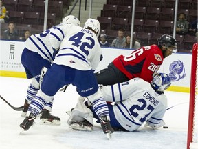 Mississauga Steelheads' goaltender Kai Edmonds tries to block Cole Purboo (26) from the Windsor Spitfires during Sunday's OHL game in Mississauga.