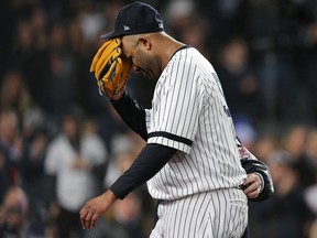 New York Yankees pitcher CC Sabathia reacts as he is walked off the field by trainer Steve Donohue at Yankee Stadium. (Brad Penner-USA TODAY Sports)