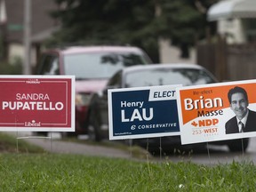 Lawn signs for Windsor West candidates from the Liberal, Conservative, and NDP parties are pictured at a home on Parent Ave. and Elliott St. East, Thursday, October 3, 2019.