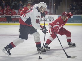 WINDSOR, ONT:. OCTOBER 24 -- Windsor's Matthew Maggio takes a shot on net while Sault Ste Marie's Holden Wale tries to get his stick on the puck in OHL action between the Windsor Spitfires and the Sault Ste Marie Greyhounds at the WFCU Centre, Thursday, October 24, 2019.
