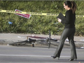 A Windsor police officer is shown on Tecumseh Road West between McKay and Crawford Avenues on Saturday, Oct. 19, 2019, at the scene of a fatal stabbing. Police have arrested and charged one man with murder and are still seeking two other suspects.