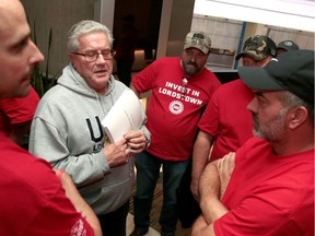 United Auto Workers (UAW) Local 1112 President Tim O'Hara holds a copy of the tentative 2019 UAW-GM contract agreement while talking with laid-off General Motors Lordstown Assembly workers following a private meeting of the UAW-GM Council at the Renaissance Center in Detroit, Michigan, U.S. October 17, 2019.