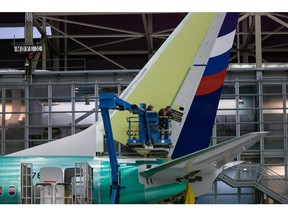 Boeing employees work on the tail of a Boeing 737 NG at the Boeing plant in Renton, Washington December 7, 2015. Picture taken December 7, 2015.