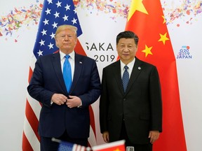 U.S. President Donald Trump poses for a photo with China's President Xi Jinping before their bilateral meeting during the G20 leaders summit in Osaka, Japan, June 29, 2019.