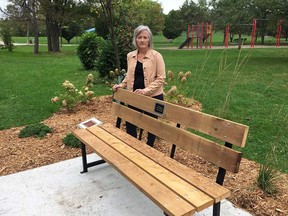 Renee Rupert stands by the bench area in Riverside Kiwanis Park dedicated to Sara Anne Widholm - the elderly Windsor woman who died last year after a brutal assault on the Ganatchio Trail in October 2017. Photographed Oct. 2, 2019.