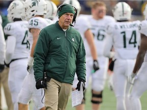 Michigan State Spartans head football coach Mark Dantonio watches the replay late in the fourth quarter of the game against the Michigan Wolverines at Michigan Stadium on November 16, 2019 in Ann Arbor, Michigan. Michigan defeated Michigan State 40-10.