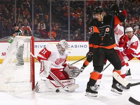 Calvin Pickard #31 of the Detroit Red Wings makes a save against Oskar Lindblom #23 of the Philadelphia Flyers in the second period at the Wells Fargo Center on Nov. 29, 2019 in Philadelphia.