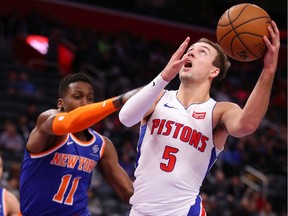 Luke Kennard #5 of the Detroit Pistons tries to take a shot around Frank Ntilikina #11 of the New York Knicks during the second half at Little Caesars Arena on November 06, 2019 in Detroit, Michigan. Detroit won the game 122-102.