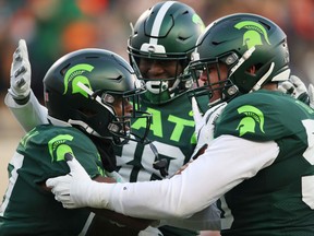 Tre Mosley of the Michigan State Spartans celebrates his first half touchdown catch with teammates while playing the Illinois Fighting Illini at Spartan Stadium on November 09, 2019 in East Lansing, Michigan.