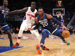 Josh Okogie #20 of the Minnesota Timberwolves tries to get around the defense of Thon Maker #7 of the Detroit Pistons during the first half at Little Caesars Arena on November 11, 2019 in Detroit, Michigan.