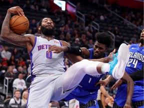 Andre Drummond #0 of the Detroit Pistons tries to control the ball next to Jonathan Isaac #1 of the Orlando Magic during the second half at Little Caesars Arena on November 25, 2019 in Detroit, Michigan. Detroit won the game 103-88.
