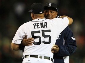 Brayan Pena of the Detroit Tigers embraces former Tiger Lou Whitaker during pre-race ceremonies for Game Four of the American League Championship Series against the Boston Red Sox at Comerica Park on October 16, 2013 in Detroit, Michigan.