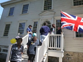 Don Wilson, top left, of Les Amis Duff-Baby, passionately explains the historical significance of the Duff-Baby House at 221 Mill Street, the oldest house west of Toronto, during Doors Open Windsor on Sept. 23, 2018.