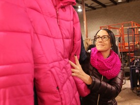 Nicole Allen, an employee of Farrow Windsor, places a winter coat on a clothing rack in a Windsor warehouse on Friday, November 1, 2019. Allen volunteered her time to lend a hand with the Unemployed Help Centre's Coats for Kids program.
