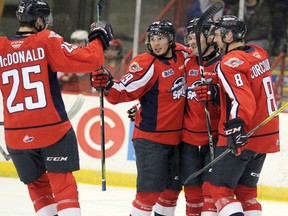 Windsor Spitfires Kyle McDonald, Daniel D'Amico, Luke Boka and Connor Corcoran celebrate a goal during first-period Ontario Hockey League action against the Sault Ste. Marie Greyhounds at GFL Memorial Gardens on Saturday.