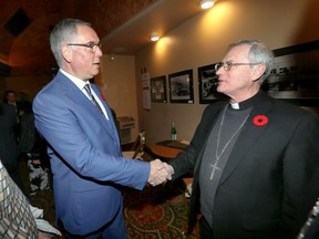Catholic church abuse survivor Pat McMahon, left, greets Bishop Ronald Fabbro during the opening night of the film PREY at Capitol Theatre Wednesday.
