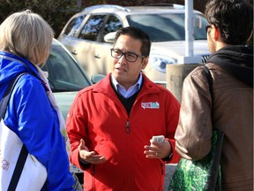 Ontario Liberal Leader candidate Alvin Tedjo, centre, speaks with visitors to Riverside Branch of Windsor Public Library Thursday.