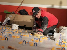 Ricky Terry, an independent contractor, lays tile down inside House of India Restaurant on Ouellette Avenue in Windsor on Thursday, November 7, 2019.