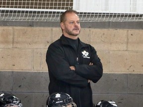 Windsor Minor Hockey Association peewee AA coach Stanley Norris — who also goes by Trent Norris — works behind the bench at the WFCU Centre on Monday.