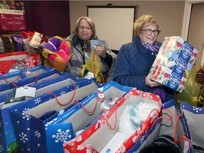 Debbie Fredriksson, left, and Trudy DiCarlo bring gifts and cash to the Be Santa to a Senior program at Home Instead Senior Care in Tecumseh. Through the Be a Santa to a Senior program, Home Instead is offering Windsor-Essex community a chance to spread joy to local seniors. Locally, Home Instead's target has already been expanded to reach 1,200 seniors, with an emphasis on facilities in the downtown core.  Items such as brand name tissues and quality skin products are appreciated.