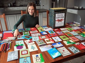 Emily Truman,16,  displays handmade holiday cards to distribute to area seniors in long-term care homes.