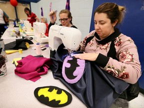 Volunteer seamstresses Melissa Renwick, right, Sheena Wieler, and about a dozen others, sew Kick-It-Capes during Maiysn's Memory Bee at Prince Andrew Public School in LaSalle Saturday afternoon.