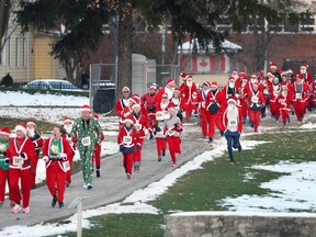 Hundreds of Super Santas enter Fort Malden National Historic Site while participating in a 5-km walk and run, a fundraiser for Essex Region Conservation Authority.