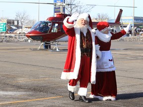 Santa and Mrs. Claus arrive by helicopter at Devonshire Mall Sunday.