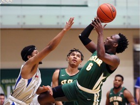 St. Clair Saints Darnell Peddie, right, fades away and shoots against Sault College's Anthony Hall in men's OCAA basketball action at the SportsPlex on Sunday.