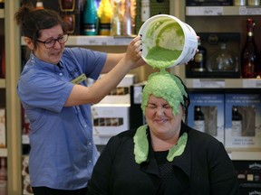 LCBO regional manager Georgina Milne, right, reacts to the slimy goo from co-worker Melissa Leary during a United Way campaign wrap up announcement at LCBO Walker Road and Ottawa Street location Thursday. In total, LCBO employees from the district collected $97,362 and Leary was the top local employee, gathering donations from 18.9 percent of her customers.