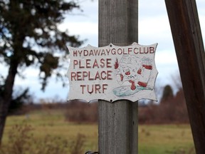 A sign reminding golfers to replace the turf is one of the reminders of the former 18-hole Hydeaway Golf Club, which is proposed to become a Catholic cemetery.
