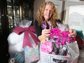 Mary-Ann Stark of Windsor Basketeers shows off beautifully wrapped gift baskets the group donates to women who are leaving Hiatus House.