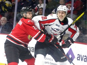 Windsor Spitfires Curtis Douglas, right, is checked by Owen Sound Attack Carter Robinson in OHL action from WFCU Centre Sunday.