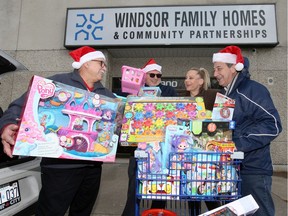 Windsor Homes Coalition executive director Angela Yakonich, centre, receives a generous donation of children's gifts from Giovanni Caboto Club representatives Gino Benotto, left, Alessandro Sorrentino and Gino Piazza, right, just in time for the Coalition's Christmas party scheduled for December 8, 2019.  The toys delivered Wednesday afternoon, were donated by Caboto Club members, who just two weeks ago, handed out winter toques, gloves and scarves to needy students.